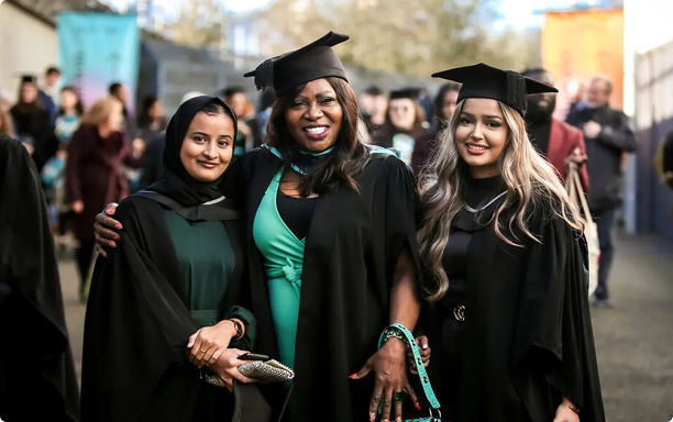 Graduate students smiling at the camera