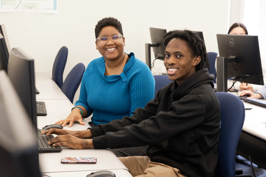 Two students working on a computer