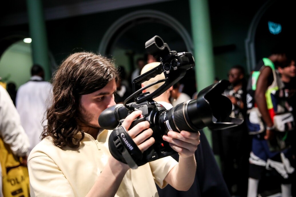 Media student holding a camera Male student holding a camera