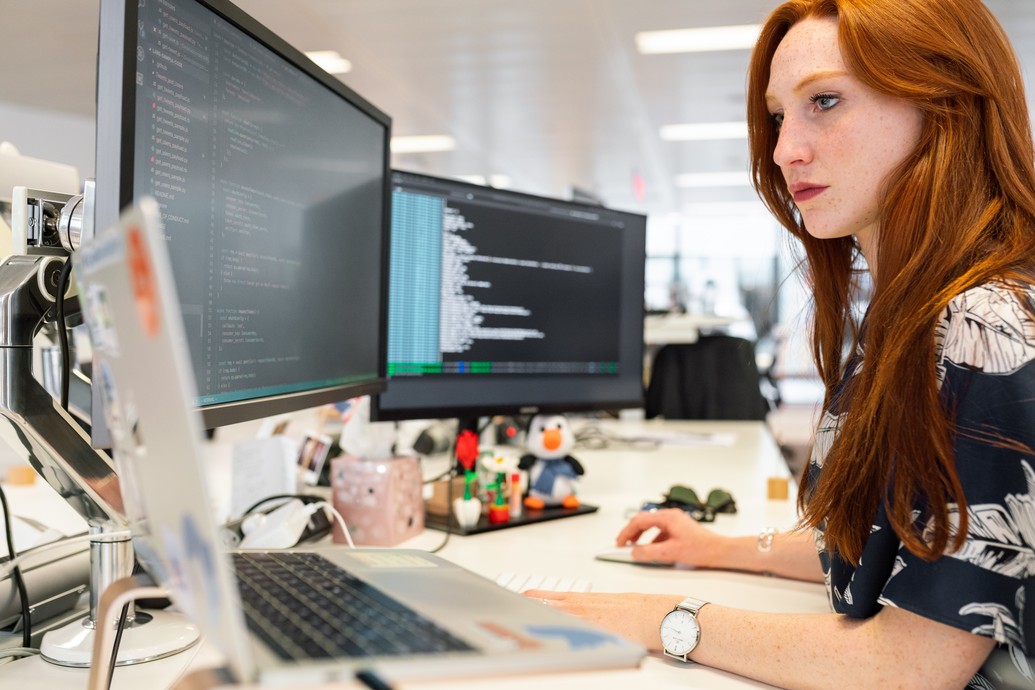 Woman sitting at computer working 7952 x 5304